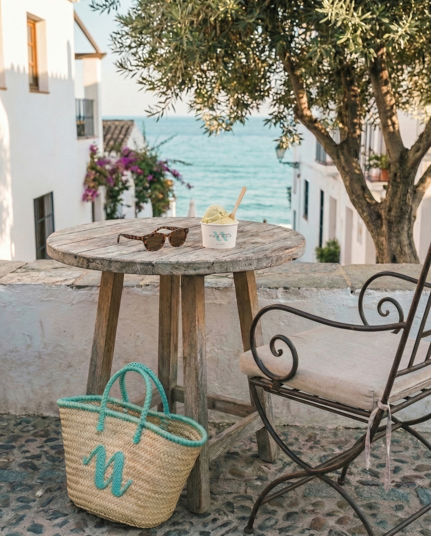 A NUANCE gelato cup with a wicker bag overlooking the sea